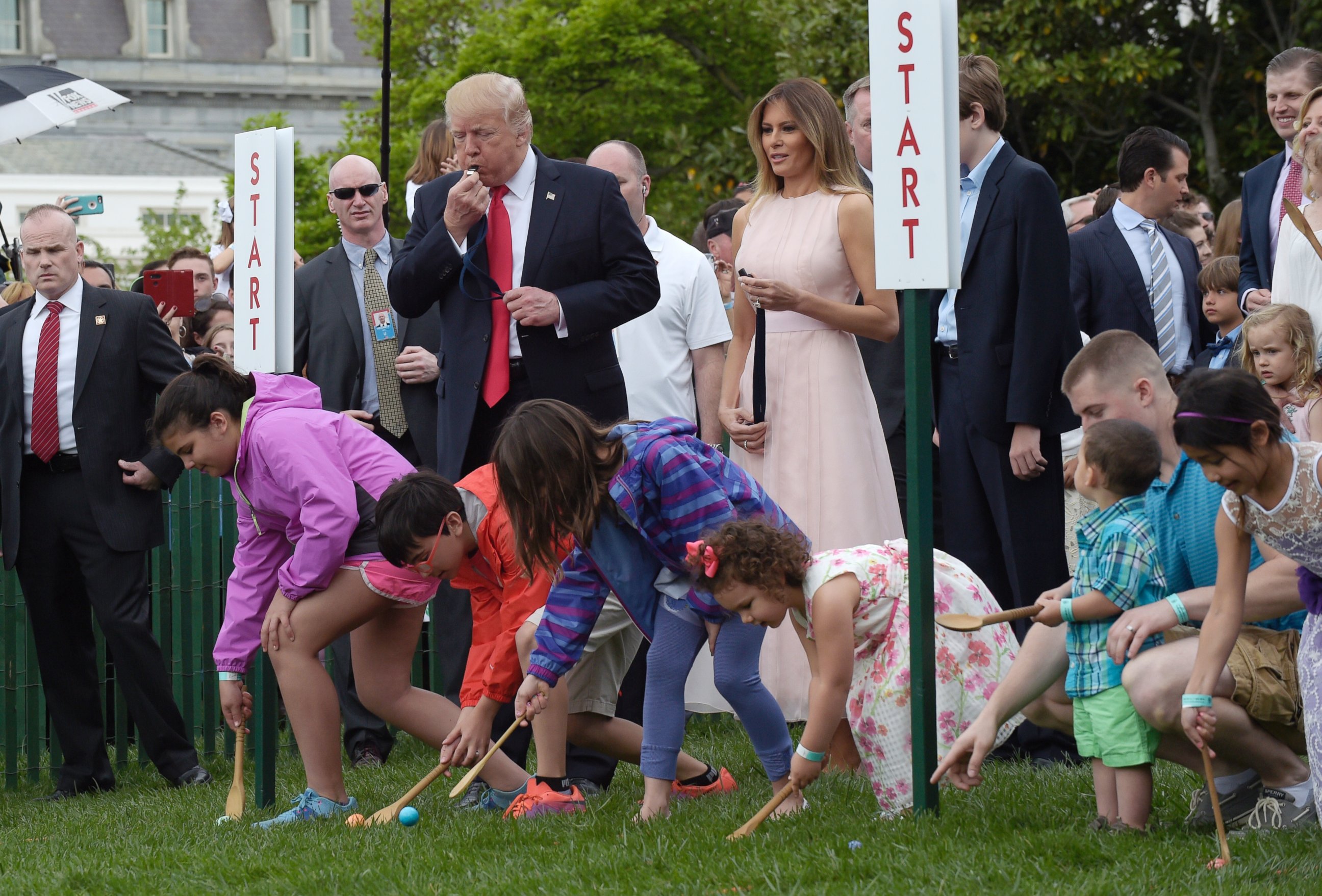 PHOTO: President Donald Trump, accompanied by first lady Melania Trump, blows a whistle to begin an Easter Egg Roll race on the South Lawn of the White House in Washington, April 17, 2017, during the annual White House Easter Egg Roll.