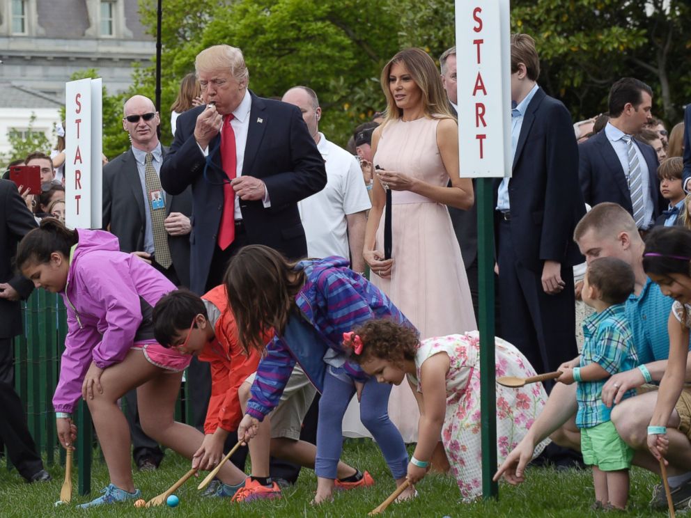 PHOTO: President Donald Trump, accompanied by first lady Melania Trump, blows a whistle to begin an Easter Egg Roll race on the South Lawn of the White House in Washington, April 17, 2017, during the annual White House Easter Egg Roll.