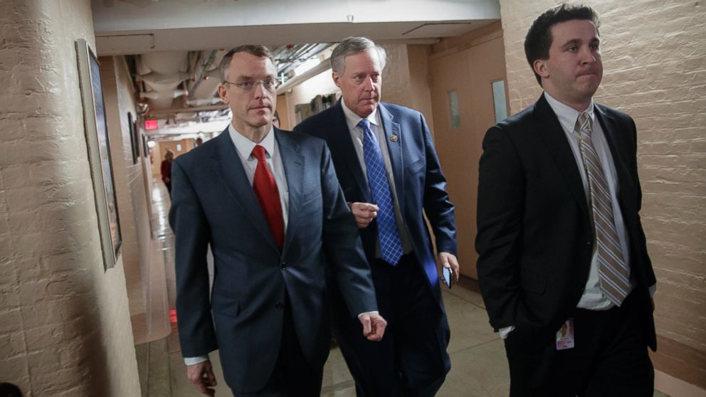 House Freedom Caucus Chairman Rep. Mark Meadows, R-N.C., center, whose conservative faction of the GOP bucked the Republican health care bill, heads to caucus meeting in the basement of the Capitol before House Speaker Paul Ryan, R-Wis., announced that he is abruptly pulling their troubled health care bill off the House floor, in Washington, March 24, 2017. 