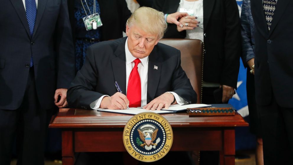 PHOTO: President Donald Trump signs an executive order for border security and immigration enforcement improvements at the Department of Homeland Security in Washington, Jan. 25, 2017. 