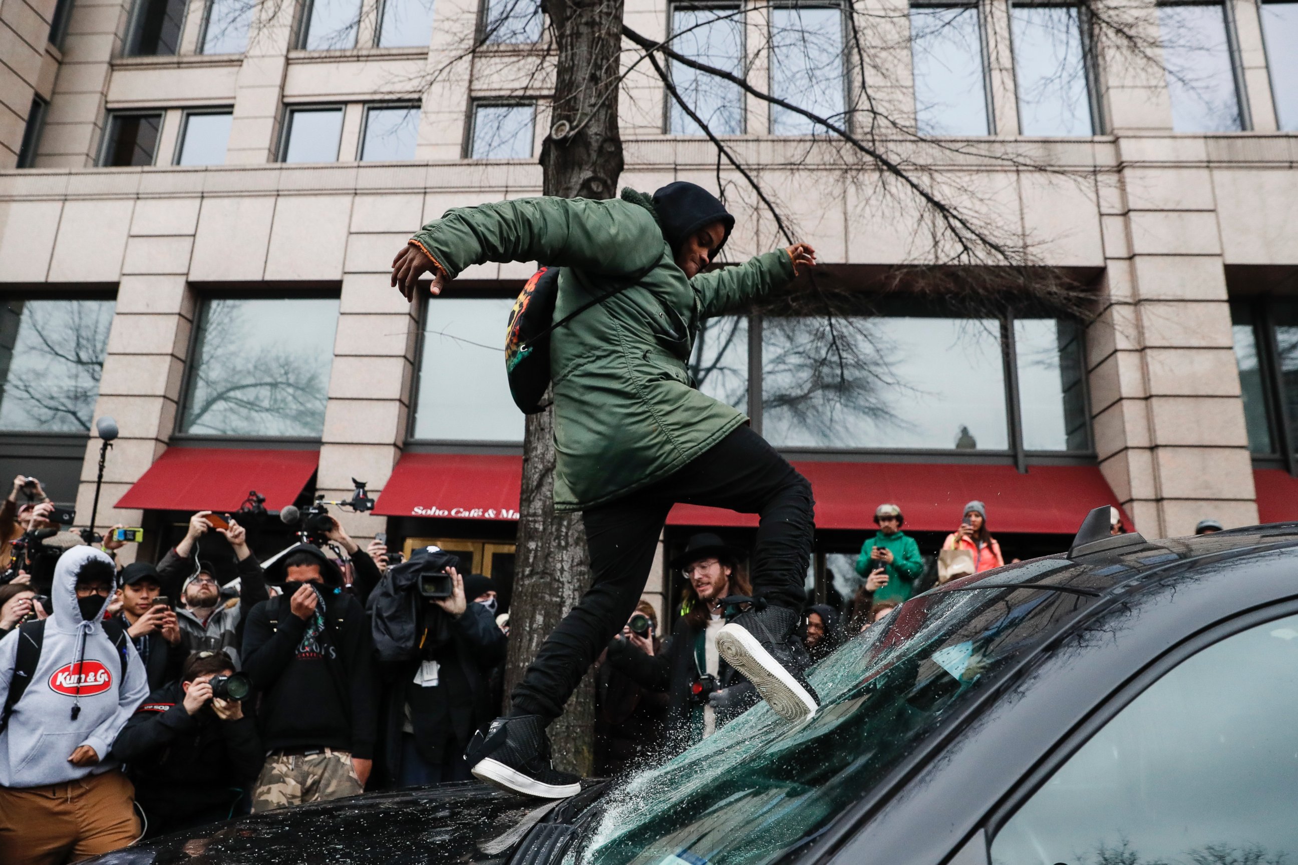 PHOTO: A protester kicks in a windshield during a demonstration in Washington, Jan. 20, 2017, after the inauguration of President Donald Trump.