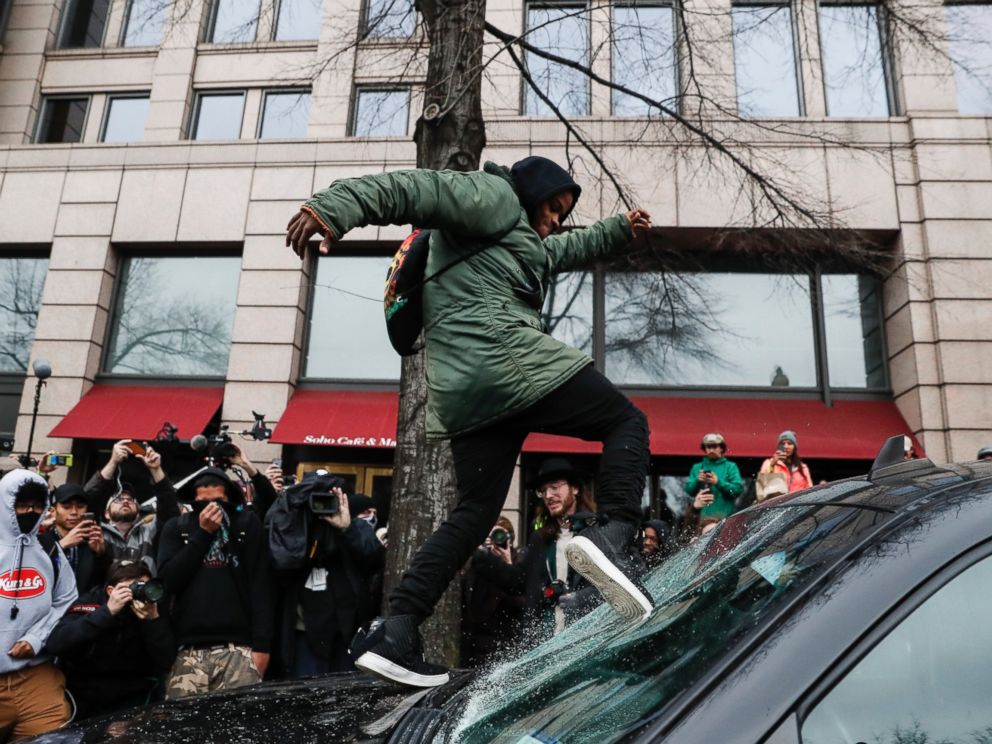 PHOTO: A protester kicks in a windshield during a demonstration in Washington, Jan. 20, 2017, after the inauguration of President Donald Trump.