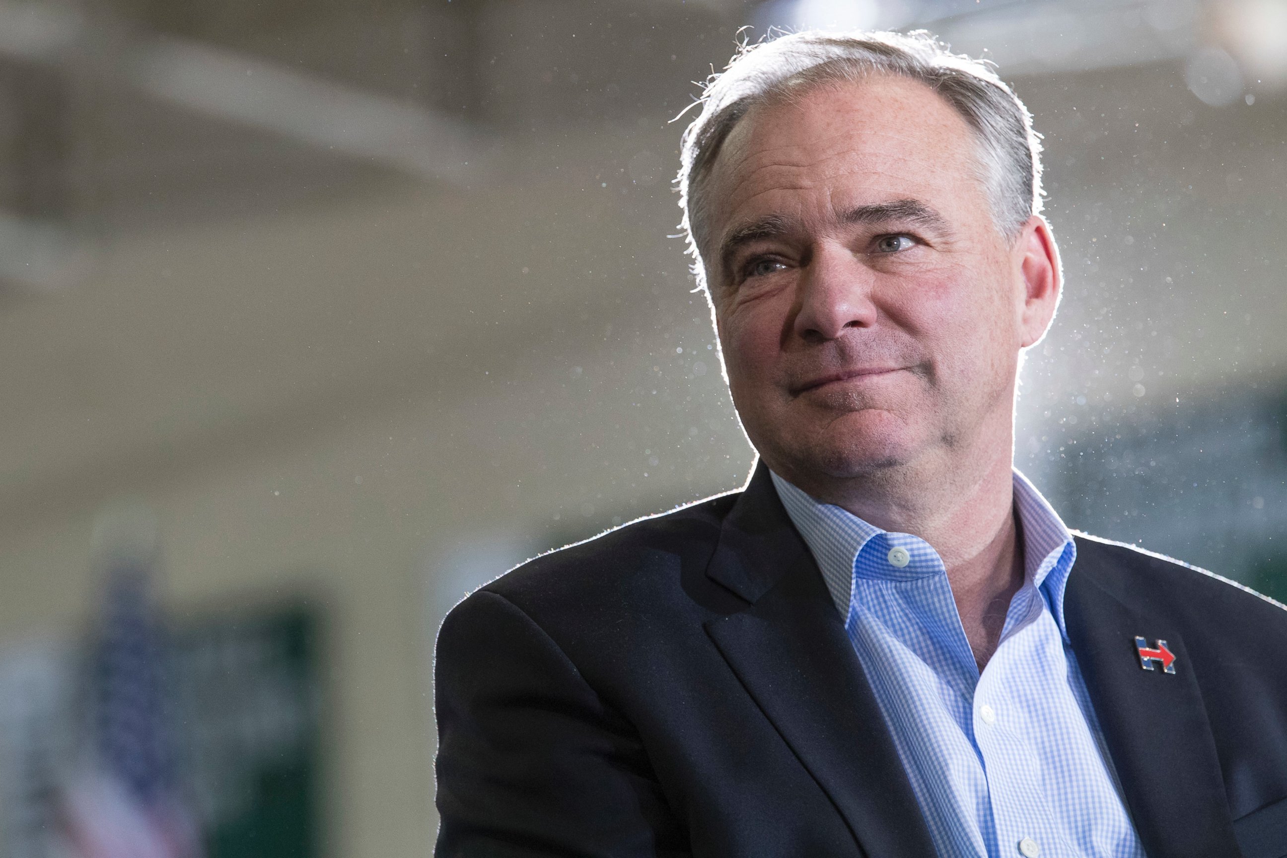 PHOTO: Democratic vice presidential candidate Sen. Tim Kaine listens as Democratic presidential candidate Hillary Clinton speaks during a campaign event at the Taylor Allderdice High School, Oct. 22, 2016, in Pittsburgh, Pennsylvania.