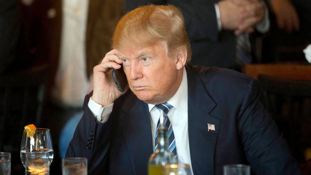 Donald Trump listens to his mobile phone during a lunch stop in North Charleston, S.C., Feb. 18, 2016. 