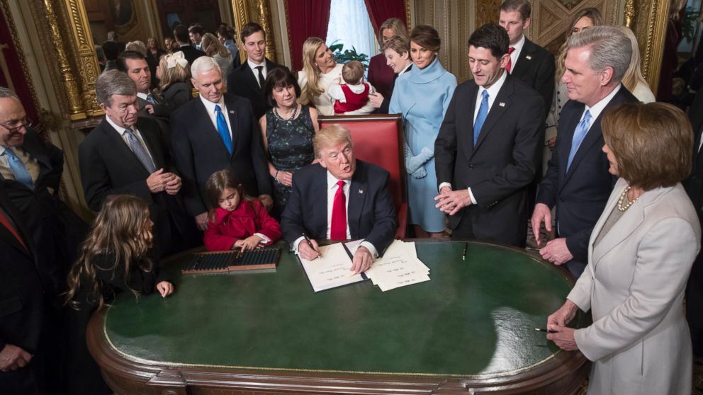 President Donald Trump is joined by the Congressional leadership and his family as he formally signs his cabinet nominations into law, in the President's Room of the Senate, at the Capitol in Washington, Friday, Jan. 20, 2017. From left are Senate Minority Leader Chuck Schumer, D-N.Y., Sen. Roy Blunt, R-Mo., Donald Trump Jr., Vice President Mike Pence, Jared Kushner, Karen Pence, Ivanka Trump, Barron Trump, Melania Trump, Speaker of the House Paul Ryan, R-Wis., Majority Leader Kevin McCarthy, D-Calif., House Minority Leader Nancy Pelosi, D-Calif. 