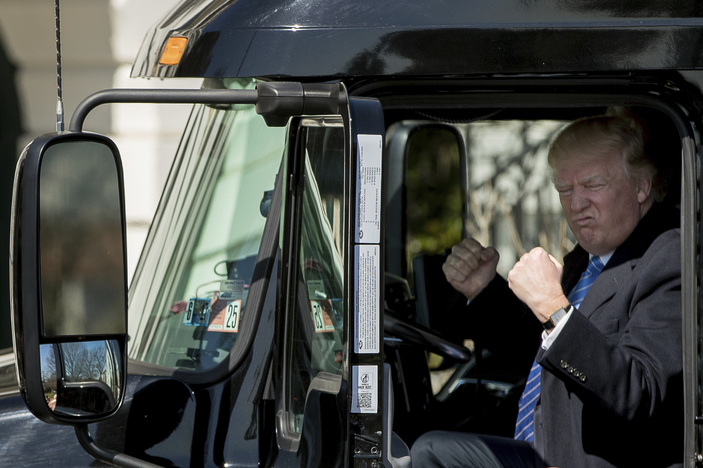 PHOTO: President Donald Trump gestures while sitting in an 18-wheeler truck while meeting with truckers and CEOs regarding healthcare on the South Lawn of the White House in Washington, March 23, 2017.