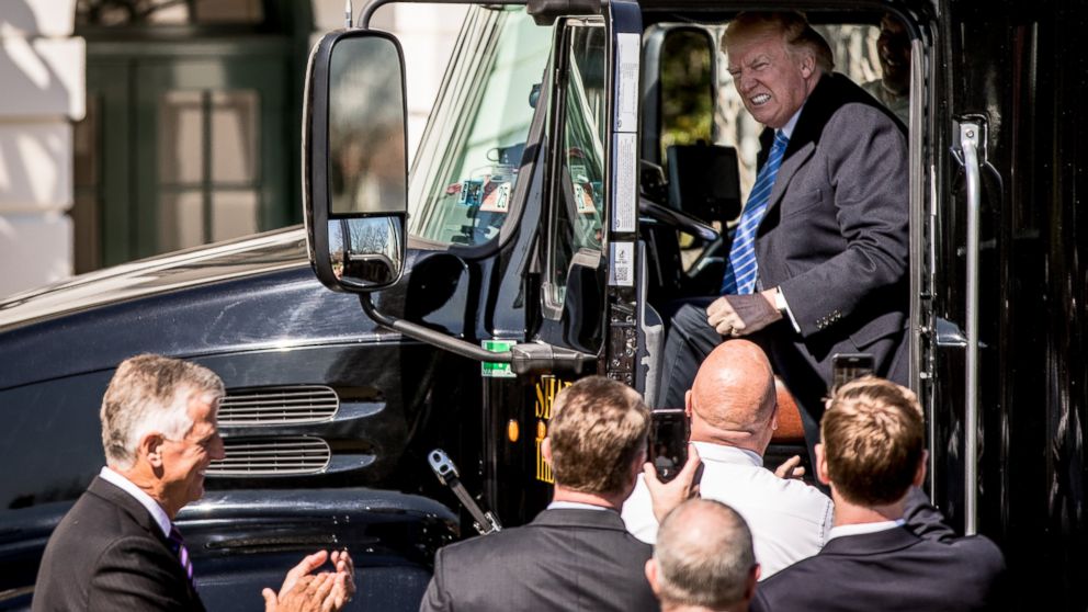 PHOTO: President Donald Trump jokes as he sits in the drivers seat of an 18-wheeler as he meets with truckers and CEOs regarding healthcare on the South Lawn of the White House, March 23, 2017, in Washington.