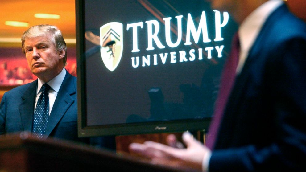 In this May 23, 2005 file photo, then real estate mogul and Reality TV star Donald Trump, left, listens as Michael Sexton introduces him at a news conference in New York where he announced the establishment of Trump University.