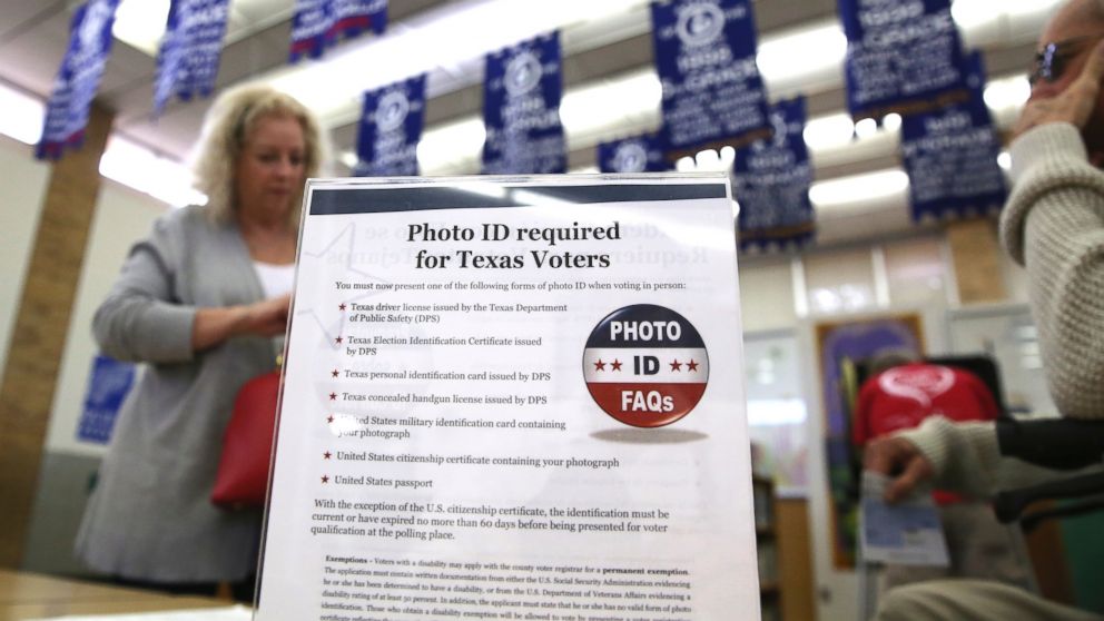PHOTO: A sign tells voters of voter ID requirements before participating in the primary election at Sherrod Elementary school in Arlington, Texas, March 1, 2016.  