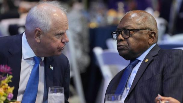 Minnesota Gov. Tim Walz speaks with Rep. Jim Clyburn, D-S.C., at the South Carolina Democratic Party's Blue Palmetto Dinner Friday, May 30, 2025, in Columbia, S.C. (AP Photo/Meg Kinnard)