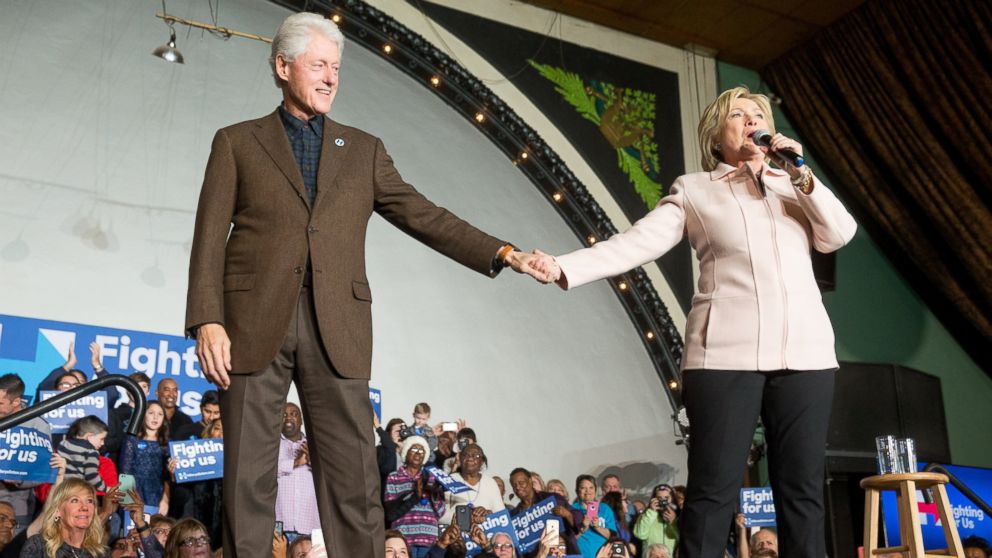 Democratic presidential candidate Hillary Clinton holds hands with her husband former President Bill Clinton as she takes the stage to speak at a rally at the Col Ballroom in Davenport, Iowa, Friday, Jan. 29, 2016. 