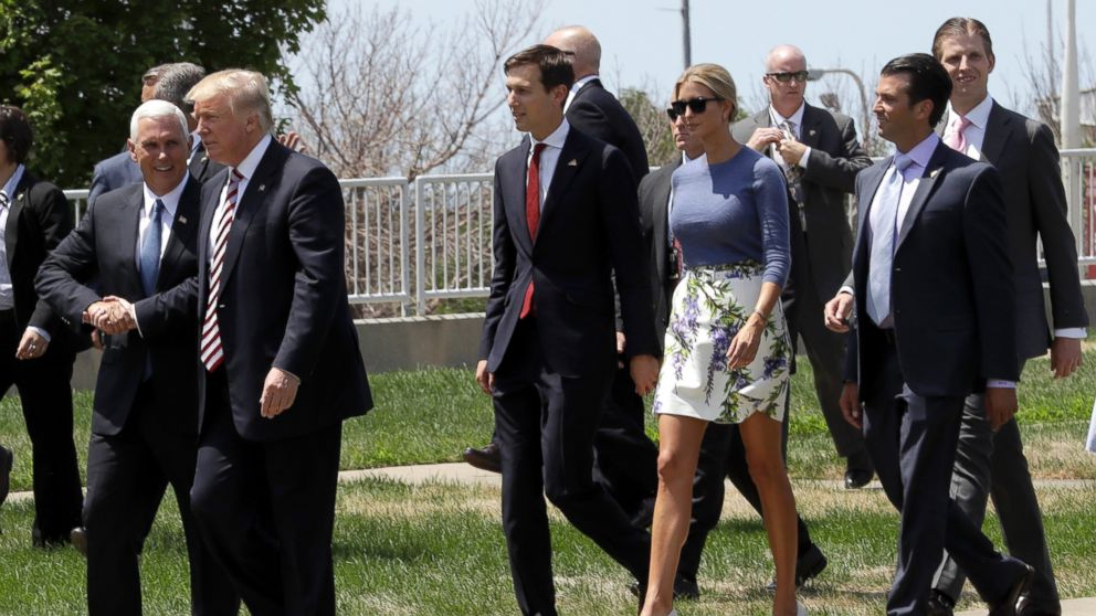Donald Trump, front right, is joined with Republican vice presidential candidate Gov. Mike Pence, R-Ind., front left, his daughter Ivanka, second from left background, her husband Jarred Kushner, left, and his sons Donald Jr. second from right, and Eric, right, after arriving via helicopter in Cleveland, Ohio, July 20, 2016.
