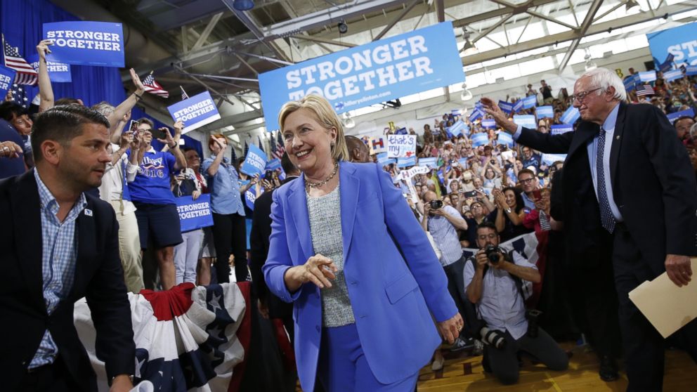 Democratic presidential candidate Hillary Clinton, followed by Sen. Bernie Sanders, I-Vt. arrives for a rally in Portsmouth, N.H., July 12, 2016.