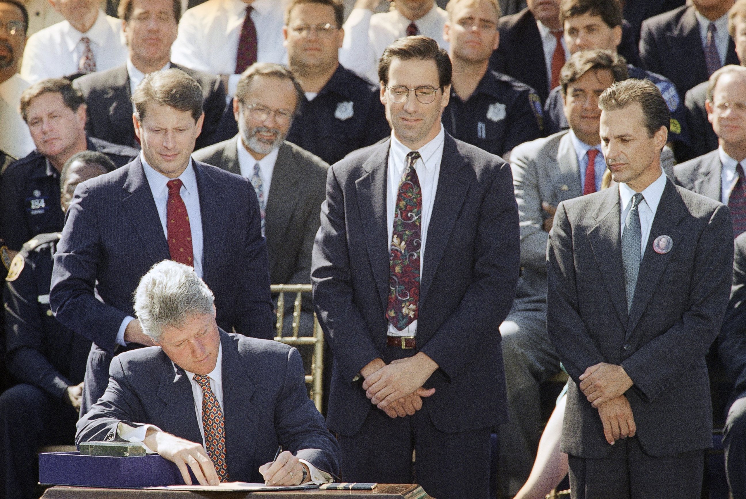 PHOTO: President Bill Clinton signs the $30 billion crime bill during a ceremony on the South Lawn of the White House in Washington on Sept. 13, 1994. 