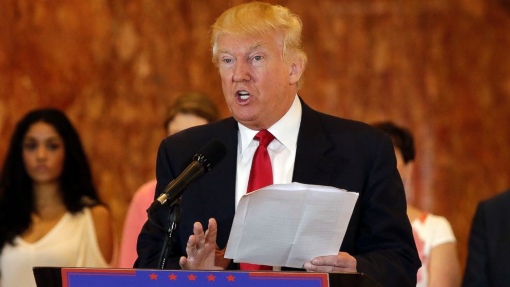 Republican presidential candidate Donald Trump reads from a list of donations to veteran's groups, during a news conference, May 31, 2016, in New York City.