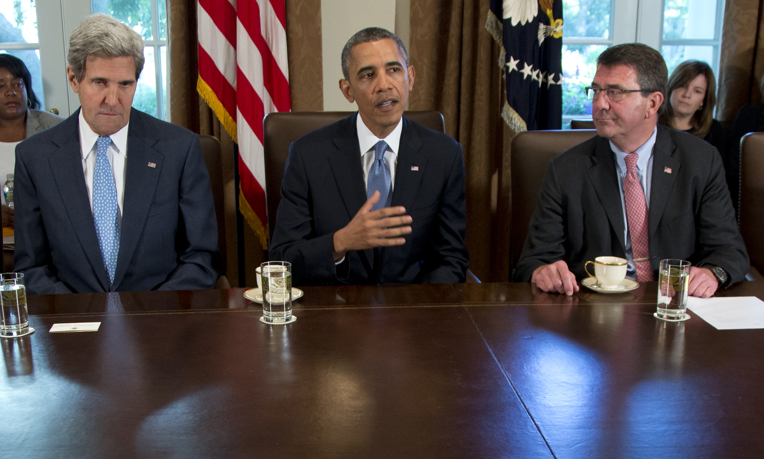 FILE - In this Sept. 30, 2013 file photo, then-Deputy Defense Secretary Ashton Carter, right, listens a President Barack Obama speaks to members of the media in the Cabinet Room of the White House. 