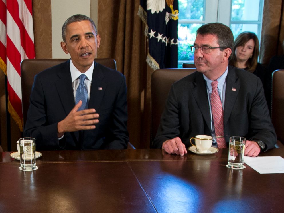 FILE - In this Sept. 30, 2013 file photo, then-Deputy Defense Secretary Ashton Carter, right, listens a President Barack Obama speaks to members of the media in the Cabinet Room of the White House.