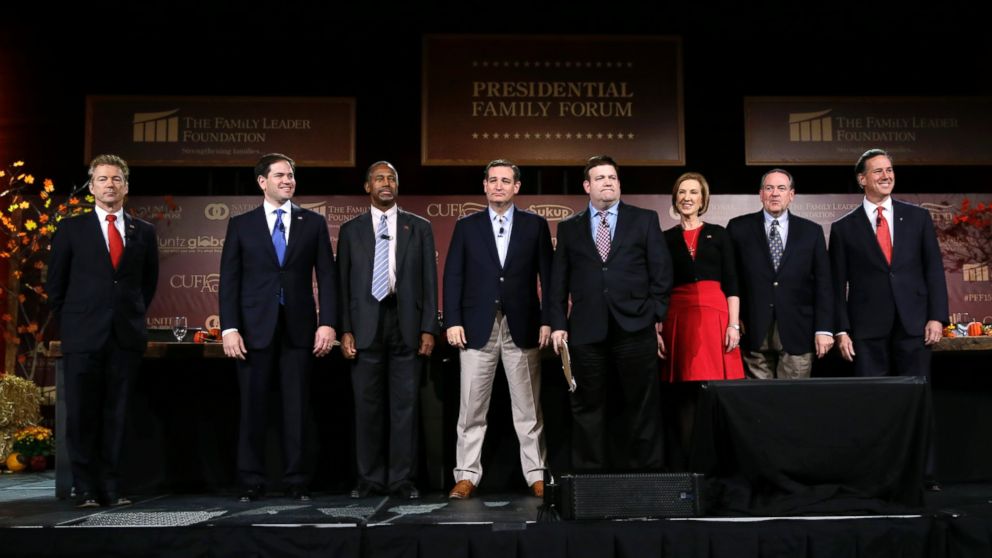 Republican presidential candidates, from left, Rand Paul, Marco Rubio, Ben Carson, Ted Cruz, moderator Frank Luntz, Carly Fiorina, Mike Huckabee and Rick Santorum stand on stage during the Presidential Family Forum, Friday, Nov. 20, 2015, in Des Moines, Iowa. 