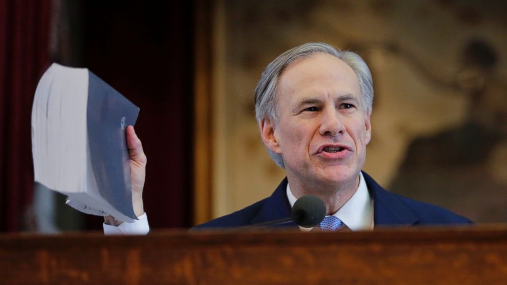 PHOTO: Texas Gov. Greg Abbott holds a book about Texas school laws as he delivers his State of the State address to a joint session of the House and Senate, Tuesday, Feb. 17, 2015, in Austin, Texas.