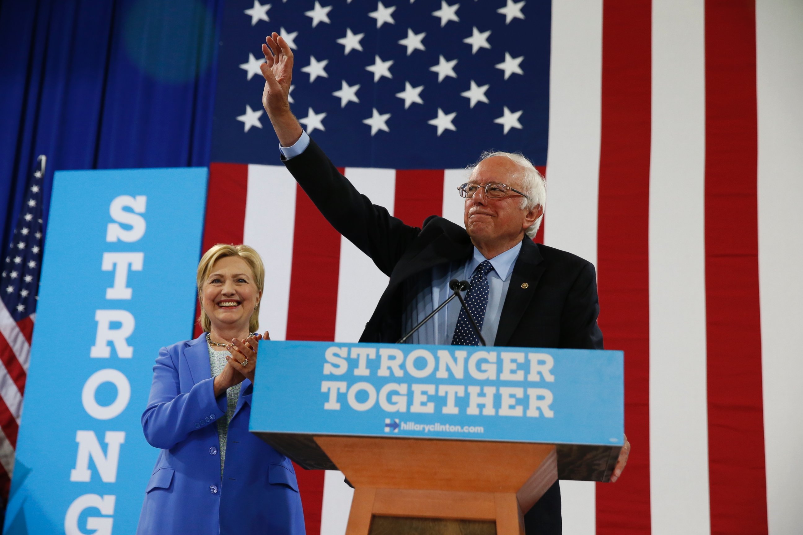 PHOTO: Sen. Bernie Sanders waves as he and Democratic presidential candidate Hillary Clinton arrive for a rally in Portsmouth, New Hampshire, July 12, 2016. 