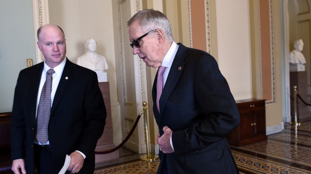 Senate Minority Leader Harry Reid of Nev. walks back to his office following a meeting with Senate Democrats on Capitol Hill in Washington, Friday, May 22, 2015. 