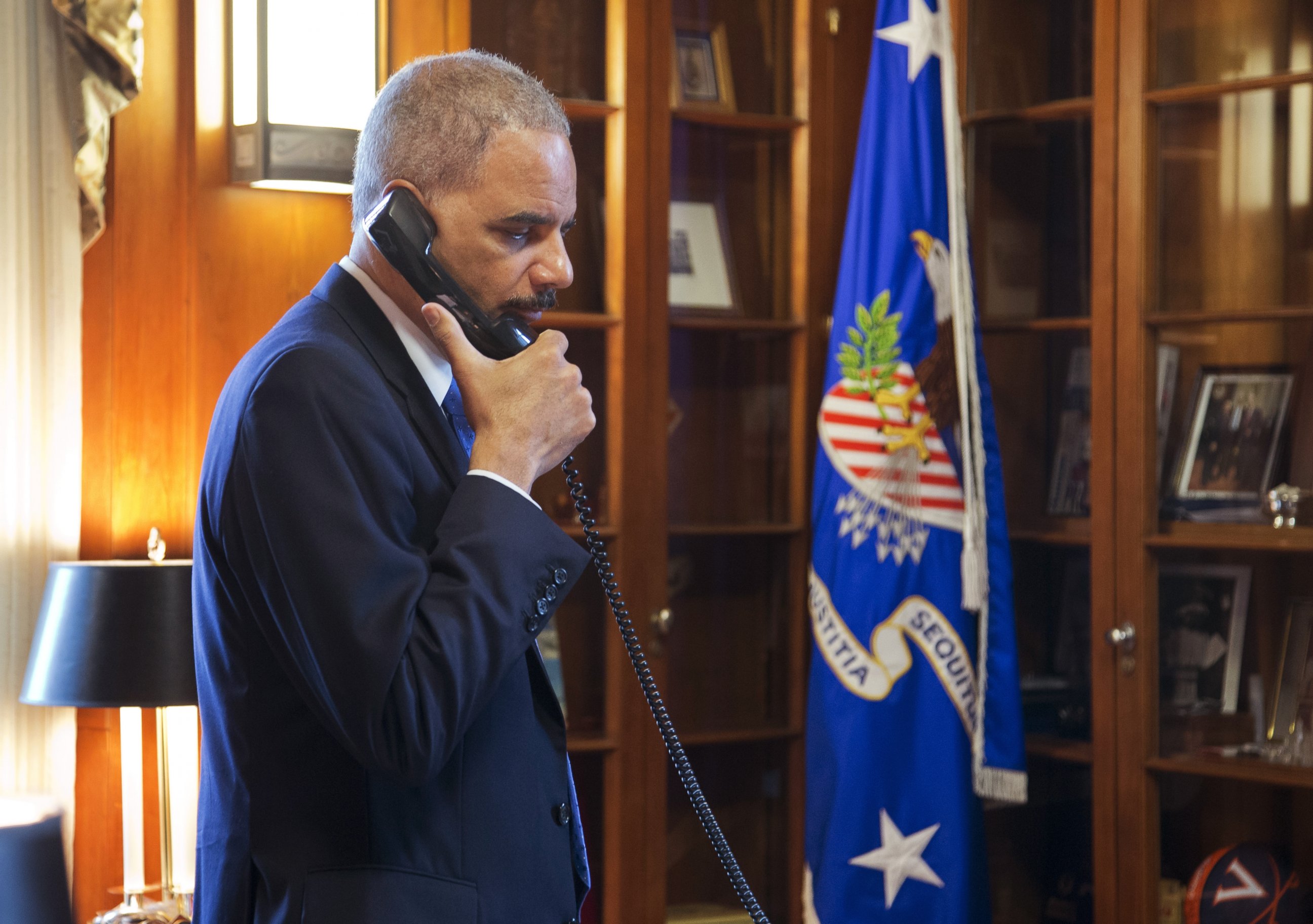 PHOTO: Attorney General Eric Holder makes calls related to the situation in Ferguson in his office at the Department of Justice in Washington, Nov. 25, 2014. 