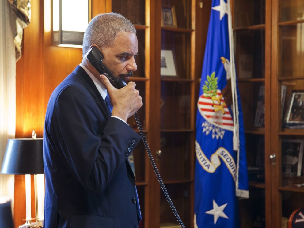 PHOTO: Attorney General Eric Holder makes calls related to the situation in Ferguson in his office at the Department of Justice in Washington, Nov. 25, 2014.