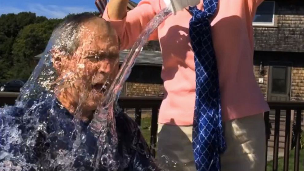 In this image from video posted on Facebook, courtesy of the George W. Bush Presidential Center, former President George W. Bush participates in the ice bucket challenge with the help of his wife, Laura Bush, in Kennebunkport, Maine.