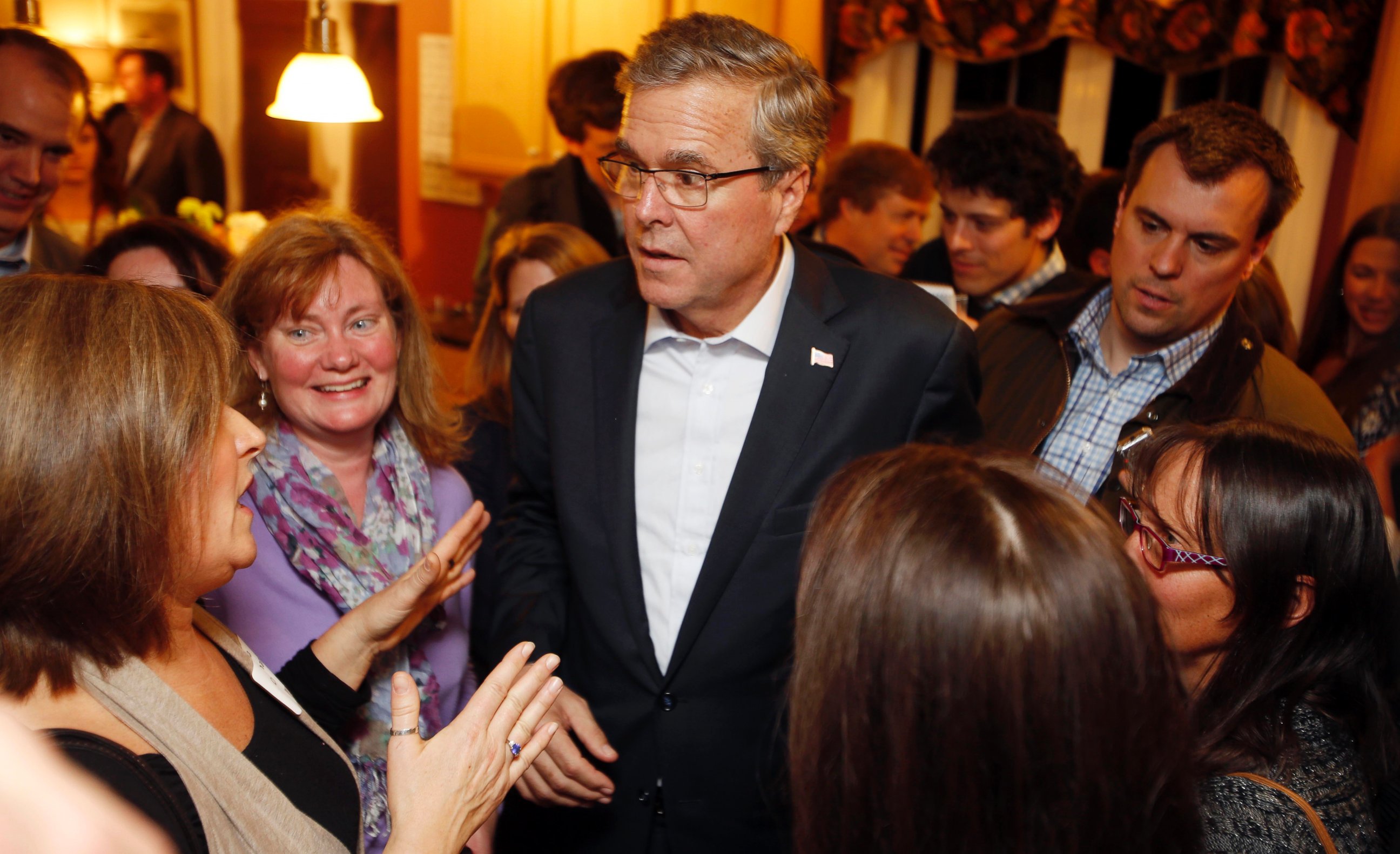 Florida Gov. Jeb Bush speaks with area residents at a packed house party Friday, March 13, 2015, in Dover, N.H. 