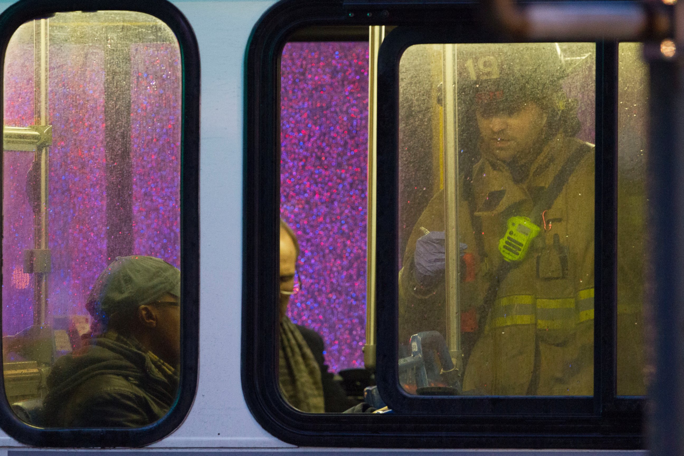 PHOTO: A firefighter attends people on a bus to assess triage needs after people were evacuated from a smoke filled Metro subway tunnel in Washington, Jan. 12, 2015.