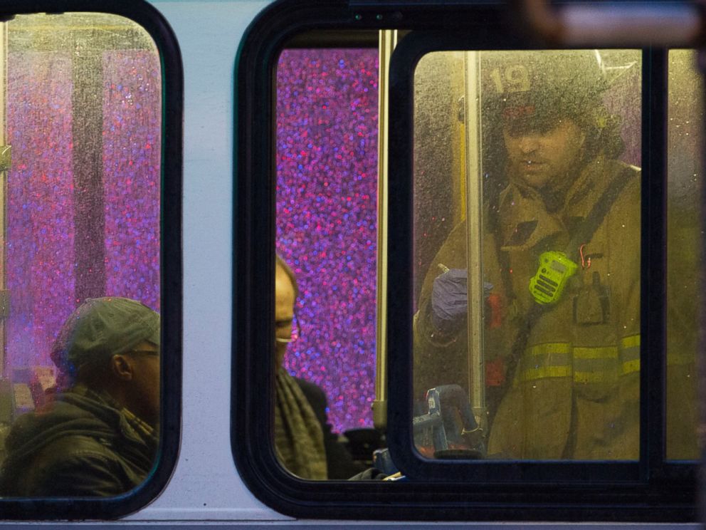 PHOTO: A firefighter attends people on a bus to assess triage needs after people were evacuated from a smoke filled Metro subway tunnel in Washington, Jan. 12, 2015.