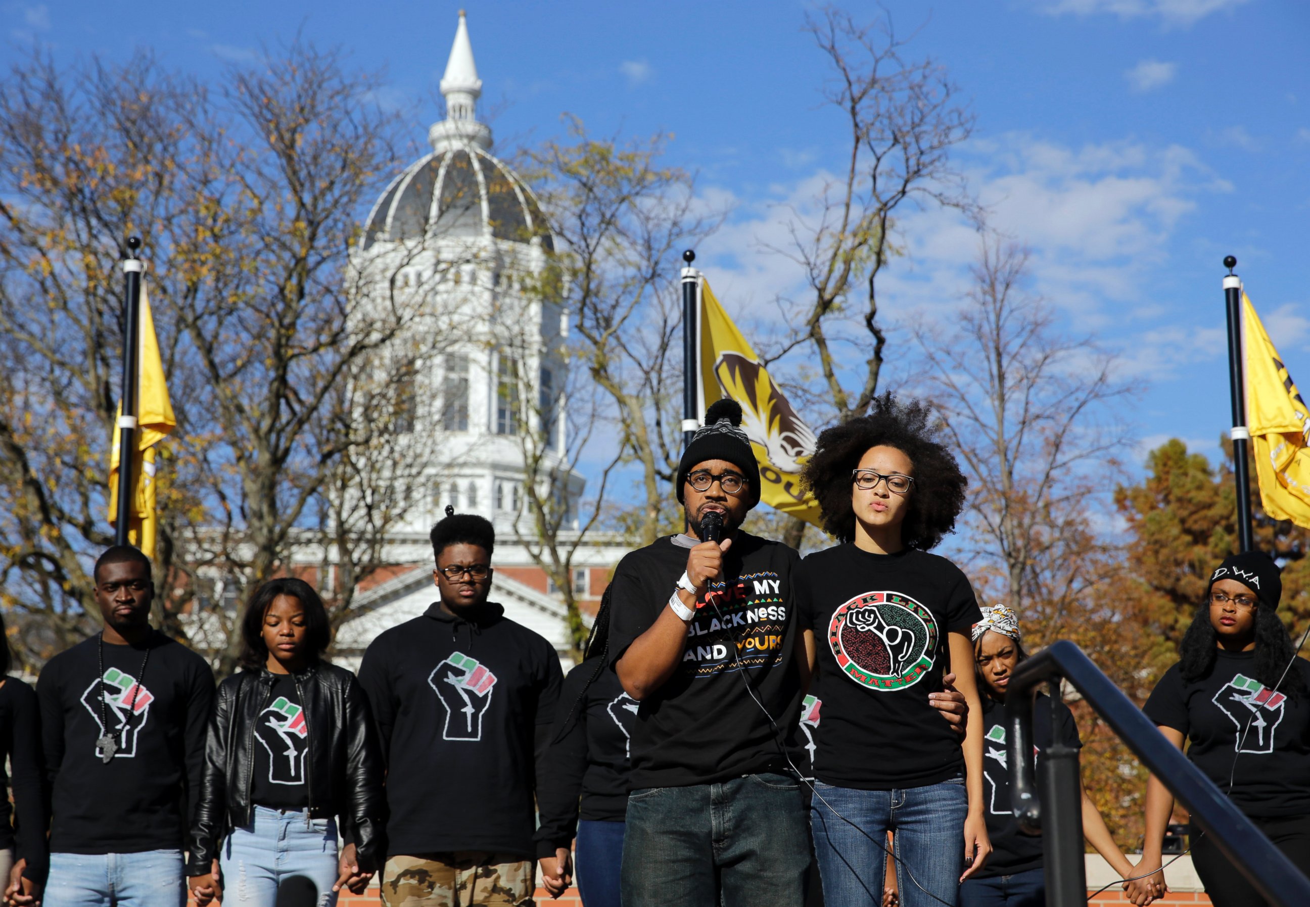 PHOTO: Jonathan Butler, front left, addresses a crowd following the announcement that University of Missouri System President Tim Wolfe would resign on Nov. 9, 2015, at the University in Columbia, Mo. 