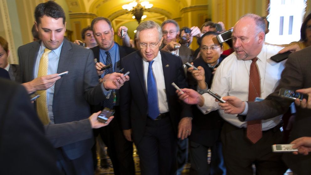 Senate Majority Leader Sen. Harry Reid, D-Nev., is surrounded by reporters after leaving the office of Senate Minority Leader Sen. Mitch McConnell, R-Ky., on Capitol Hill, Oct. 14, 2013, in Washington. 