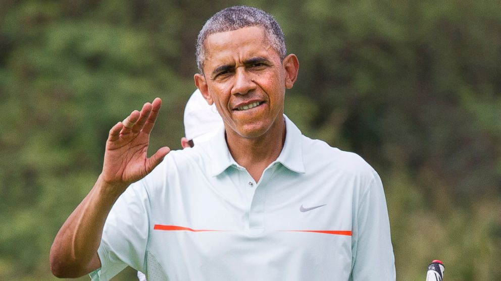 President Obama waves to the traveling press as he plays golf with Malaysian Prime Minister Najib Razak Wednesday, Dec. 24, 2014, at Marine Corps Base Hawaii's Kaneohe Klipper Golf Course in Kaneohe, Hawaii, during the Obama family vacation.