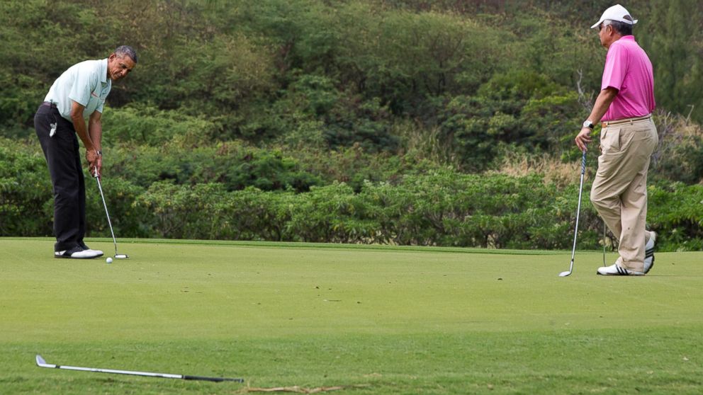 President Barack Obama plays golf with Malaysian Prime Minister Najib Razak, right, Wednesday, Dec. 24, 2014, at Marine Corps Base Hawaii's Kaneohe Klipper Golf Course in Kaneohe, Hawaii during the Obama family vacation.