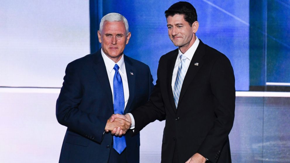 GOP Vice Presidential nominee Indiana Gov. Mike Pence, left, shakes hands with Speaker of the House Paul Ryan (R-WI) as Pence takes the stage to speak at the 2016 Republican National Convention in Cleveland, Ohio, July 20, 2016. 