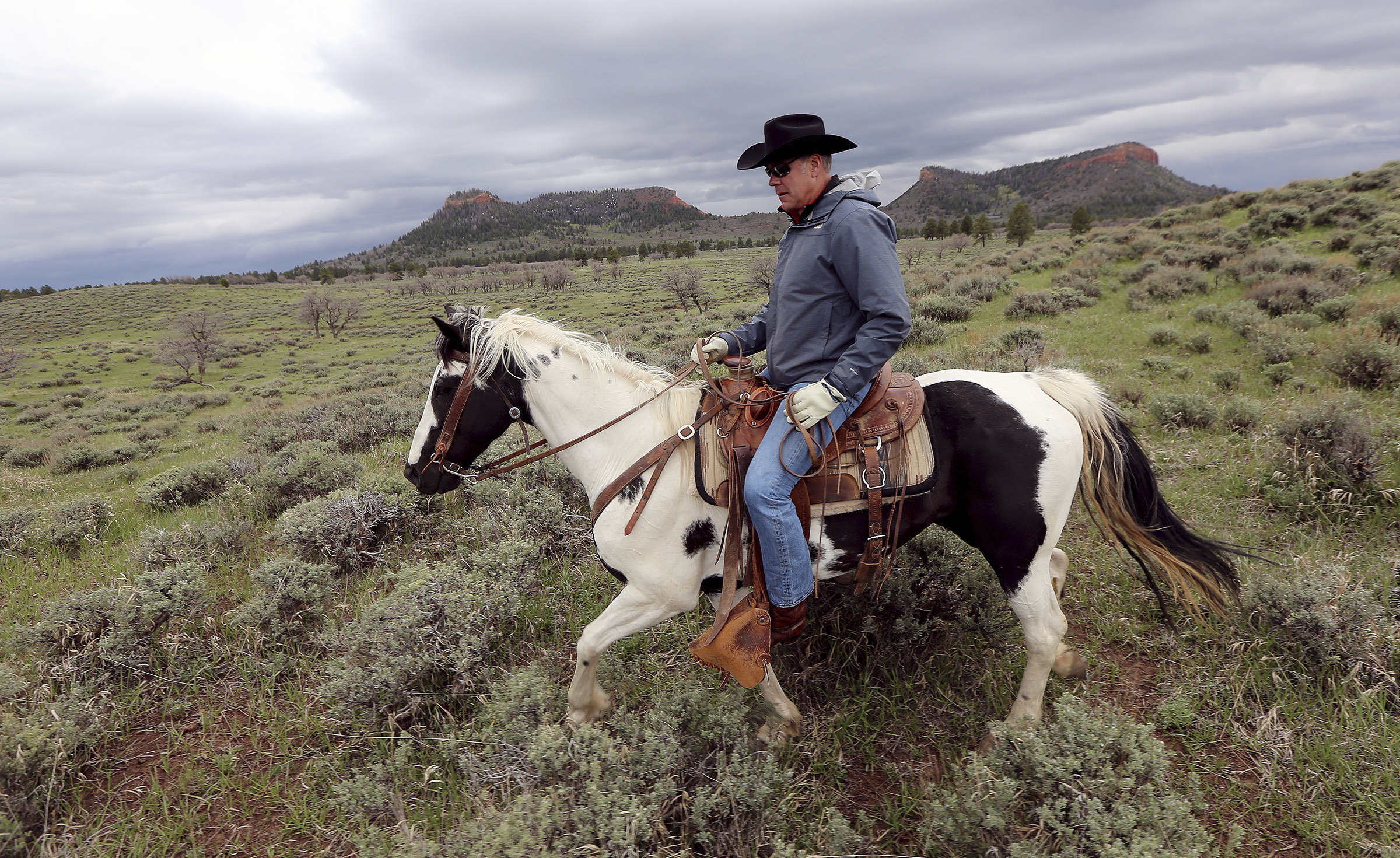 In this May 9, 2017, file photo, Interior Secretary Ryan Zinke rides a horse in the new Bears Ears National Monument near Blanding, Utah.