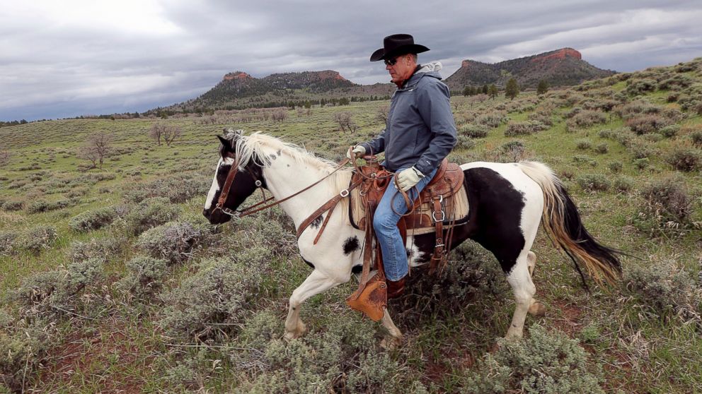 FILE - In this May 9, 2017, file photo, Interior Secretary Ryan Zinke rides a horse in the new Bears Ears National Monument near Blanding, Utah. 
