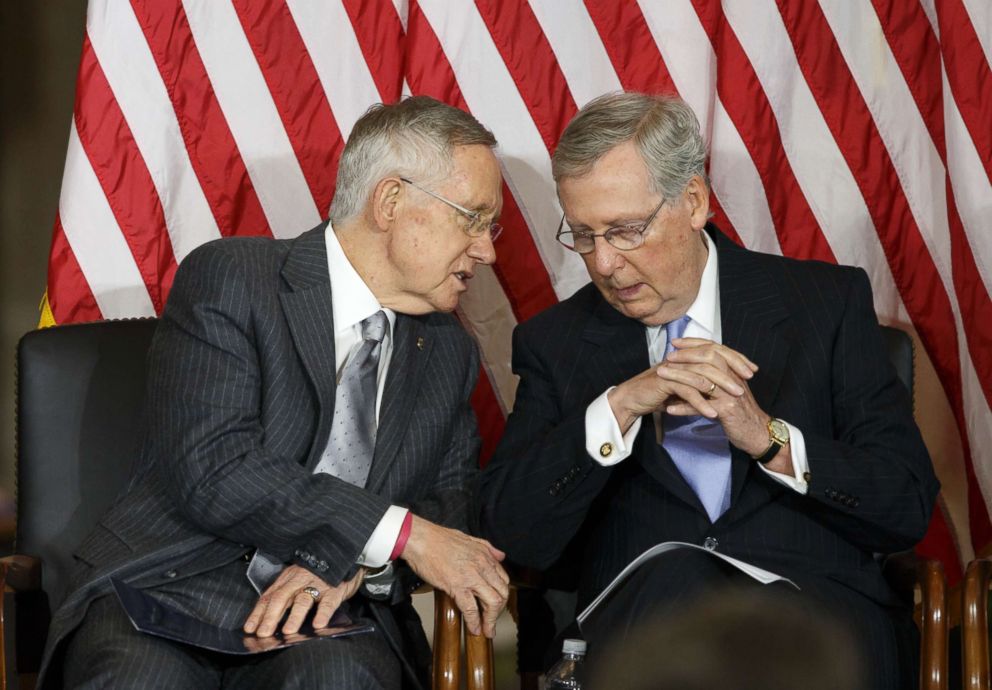 PHOTO: Senate Majority Leader Harry Reid of Nev., left, talks with Senate Minority Leader Mitch McConnell of Ky., on Capitol Hill in Washington, Sept. 10, 2014, as Congress honored victims of the terror attacks of September 11, 2001.  