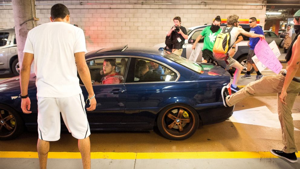 PHOTO: Protesters against Republican presidential candidate Donald Trump kick and jump on a car leaving a Trump campaign rally on Thursday, June 2, 2016, in San Jose, Calif. 