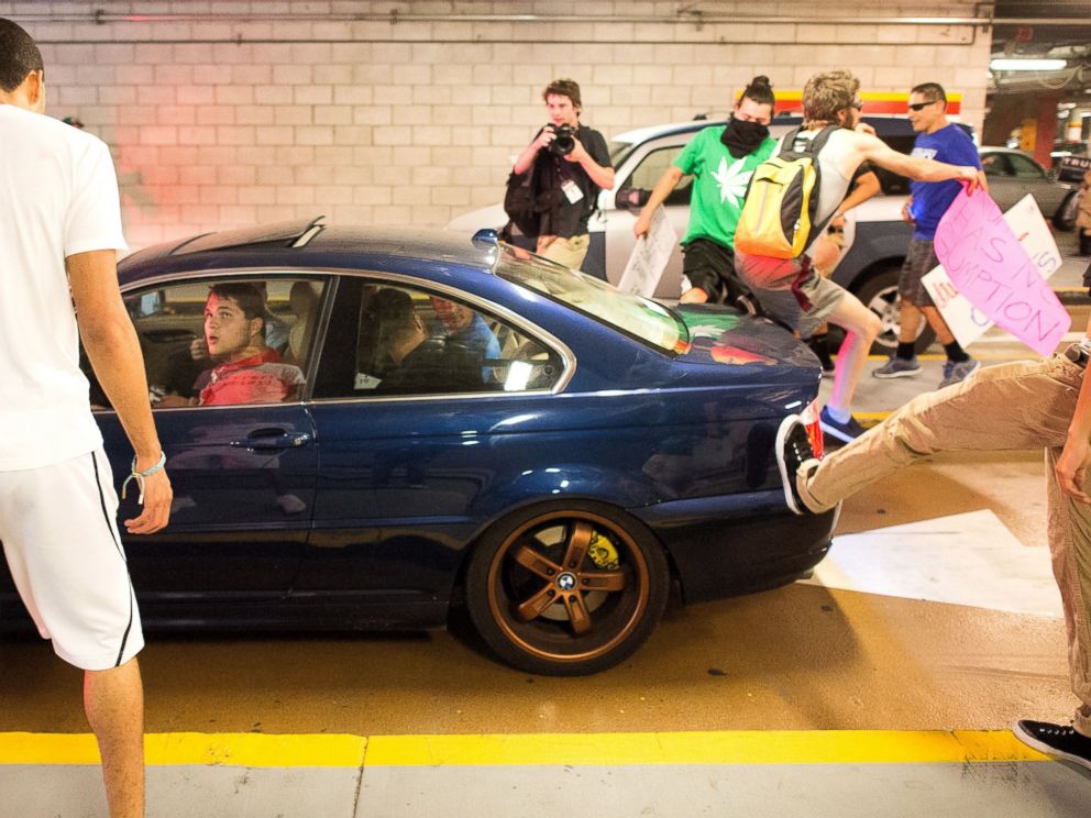 PHOTO: Protesters against Republican presidential candidate Donald Trump kick and jump on a car leaving a Trump campaign rally on Thursday, June 2, 2016, in San Jose, Calif.