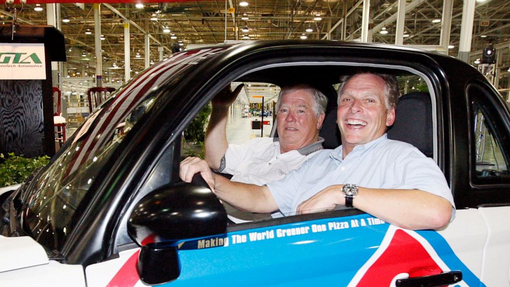 Former Mississippi Gov. Haley Barbour, left, and GreenTech Automotive chairman Terry McAuliffe take a quick spin in the plant after the unveiling of the company's new electric MyCar in Horn Lake, Miss., July 5, 2012.