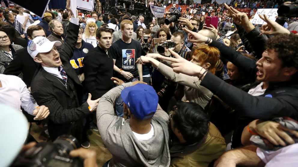 Supporters of Republican presidential candidate Donald Trump, left, face off with protesters after a rally on the campus of the University of Illinois-Chicago was cancelled due to security concerns Friday, March 11, 2016, in Chicago.