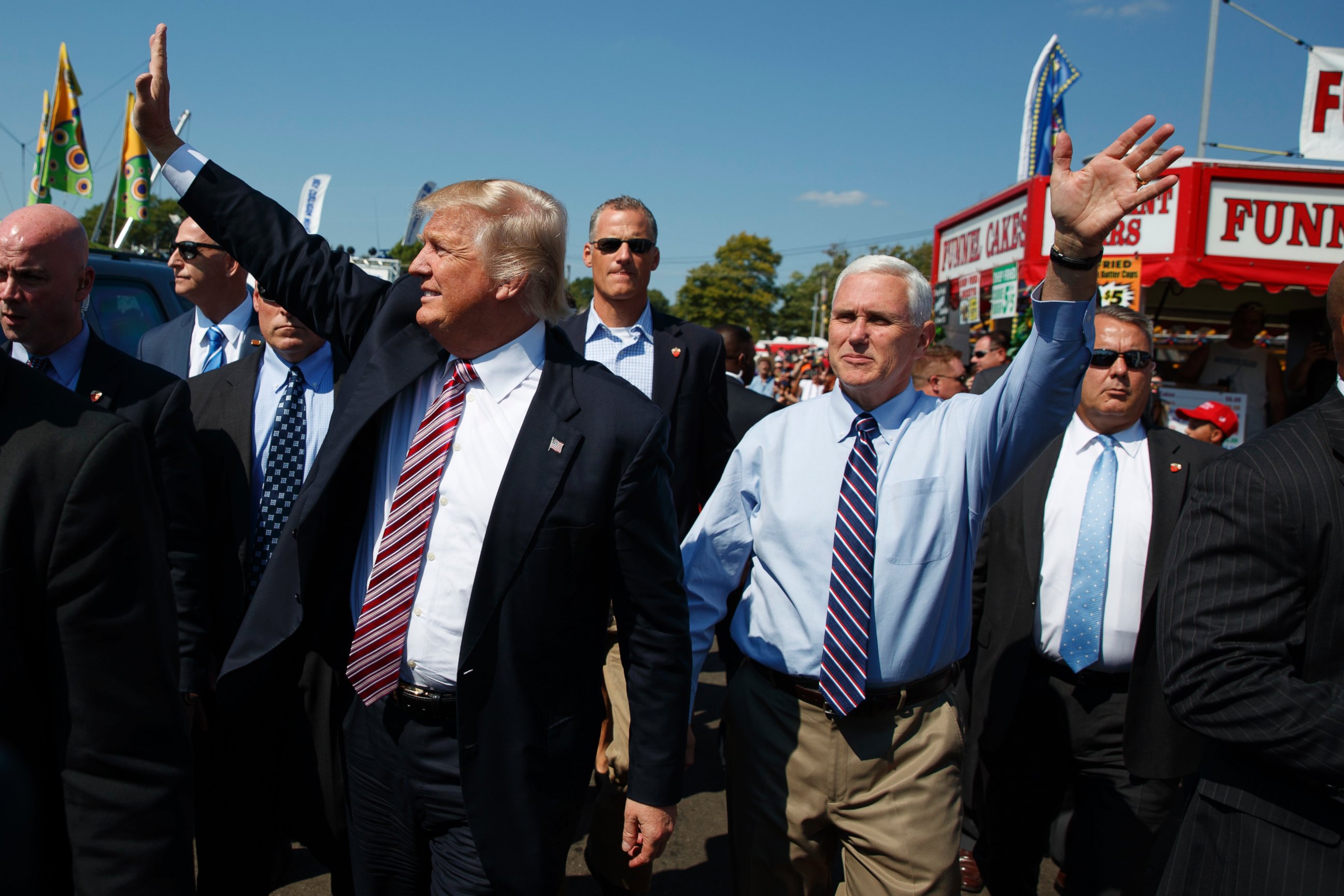 PHOTO:Republican presidential candidate Donald Trump, center left, waves as he walks with vice presidential candidate Gov. Mike Pence, R-Ind., center right, during a visit to the Canfield Fair, Sept. 5, 2016, in Canfield, Ohio.