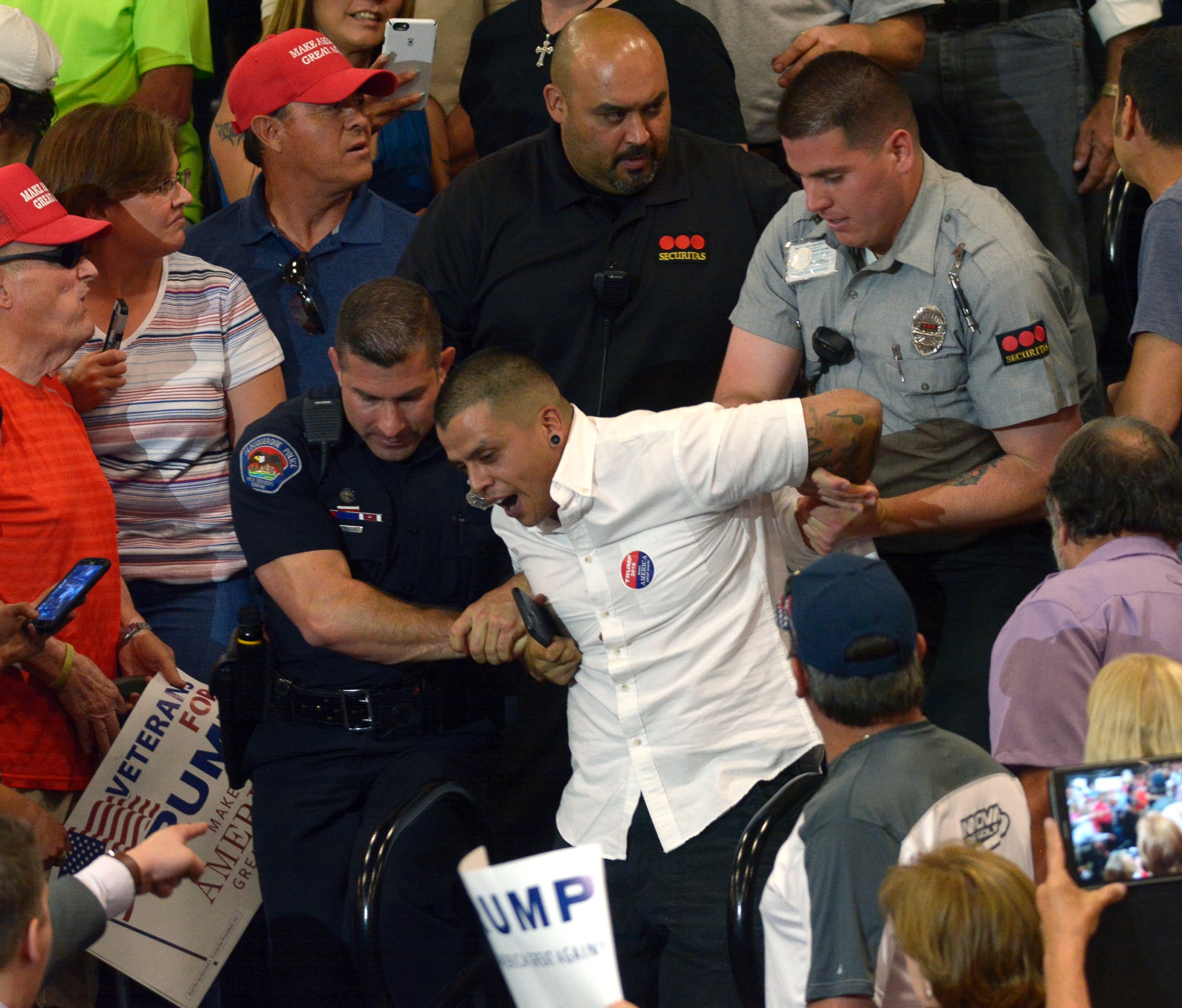 PHOTO: A protester is escorted out of the Albuquerque Convention Center during a rally for Republican presidential candidate Donald Trump, May 24, 2016, in Albuquerque.