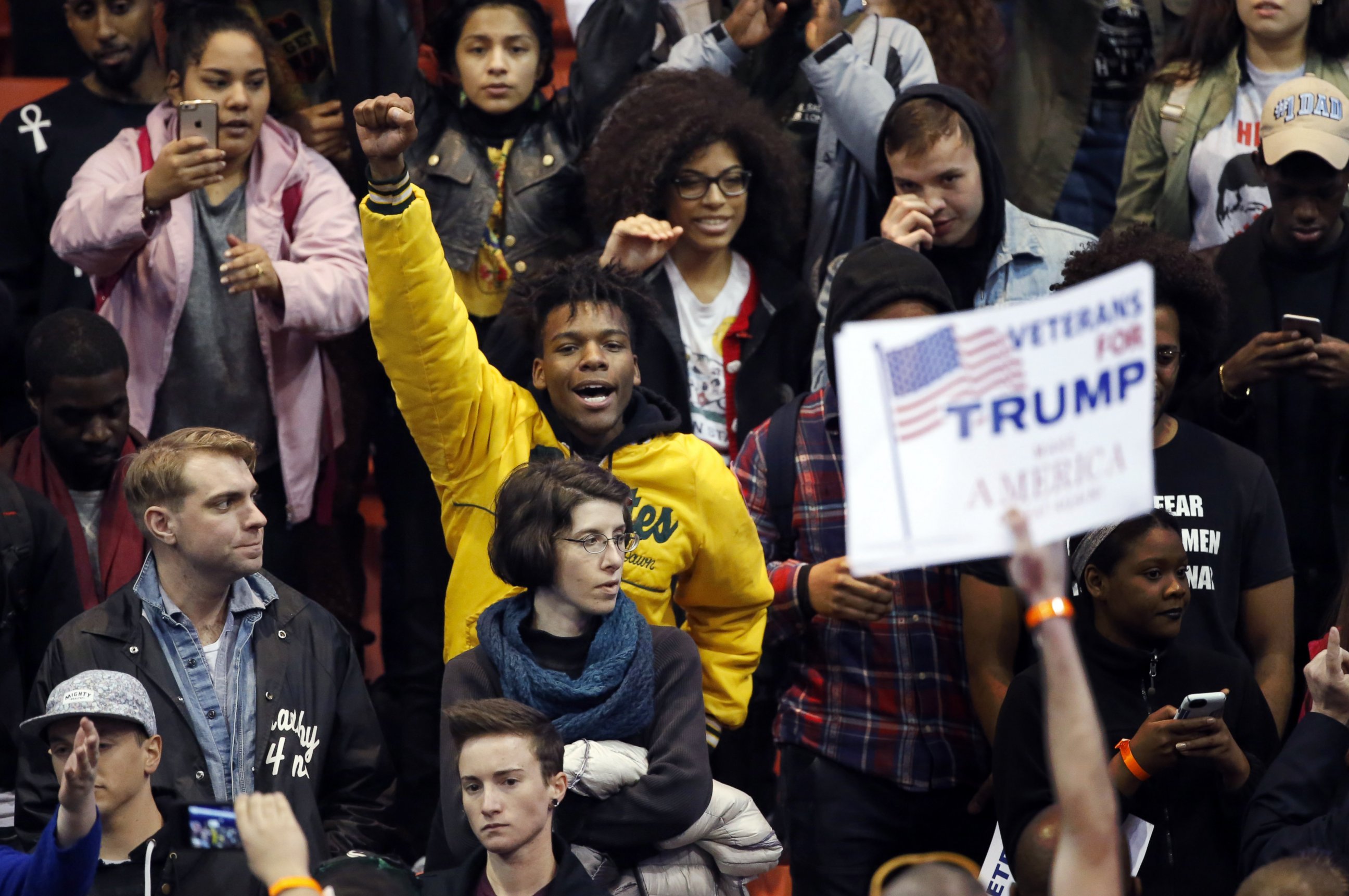 PHOTO: A protester raises his fist to supporters of Republican presidential candidate Donald Trump before a rally on the campus of the University of Illinois-Chicago, March 11, 2016, in Chicago.
