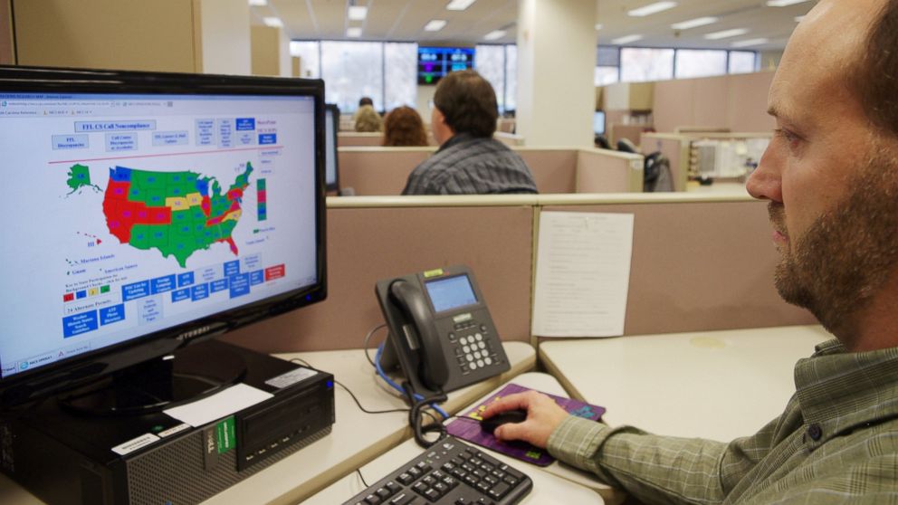 A researcher simulates a check done for the National Instant Criminal Background Check System or NICS, at the FBI's criminal justice center in Bridgeport, W.Va., Nov. 18, 2014. 