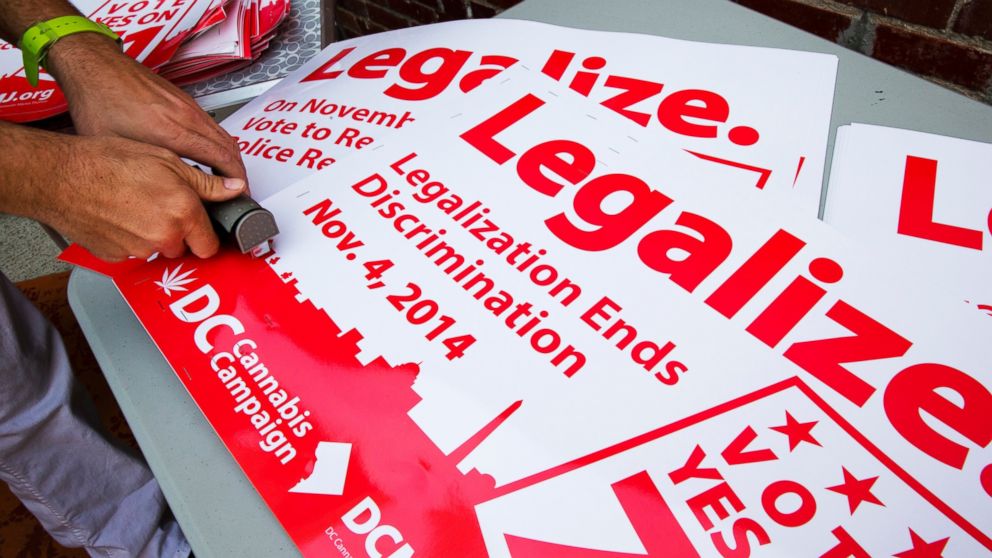 Adam Eidinger, chairman of the DC Cannabis Campaign, works on posters encouraging people to vote yes on DC Ballot Initiative 71 to legalize small amounts of marijuana for personal use, in Washington. in this, Oct. 9, 2014, file photo.  
