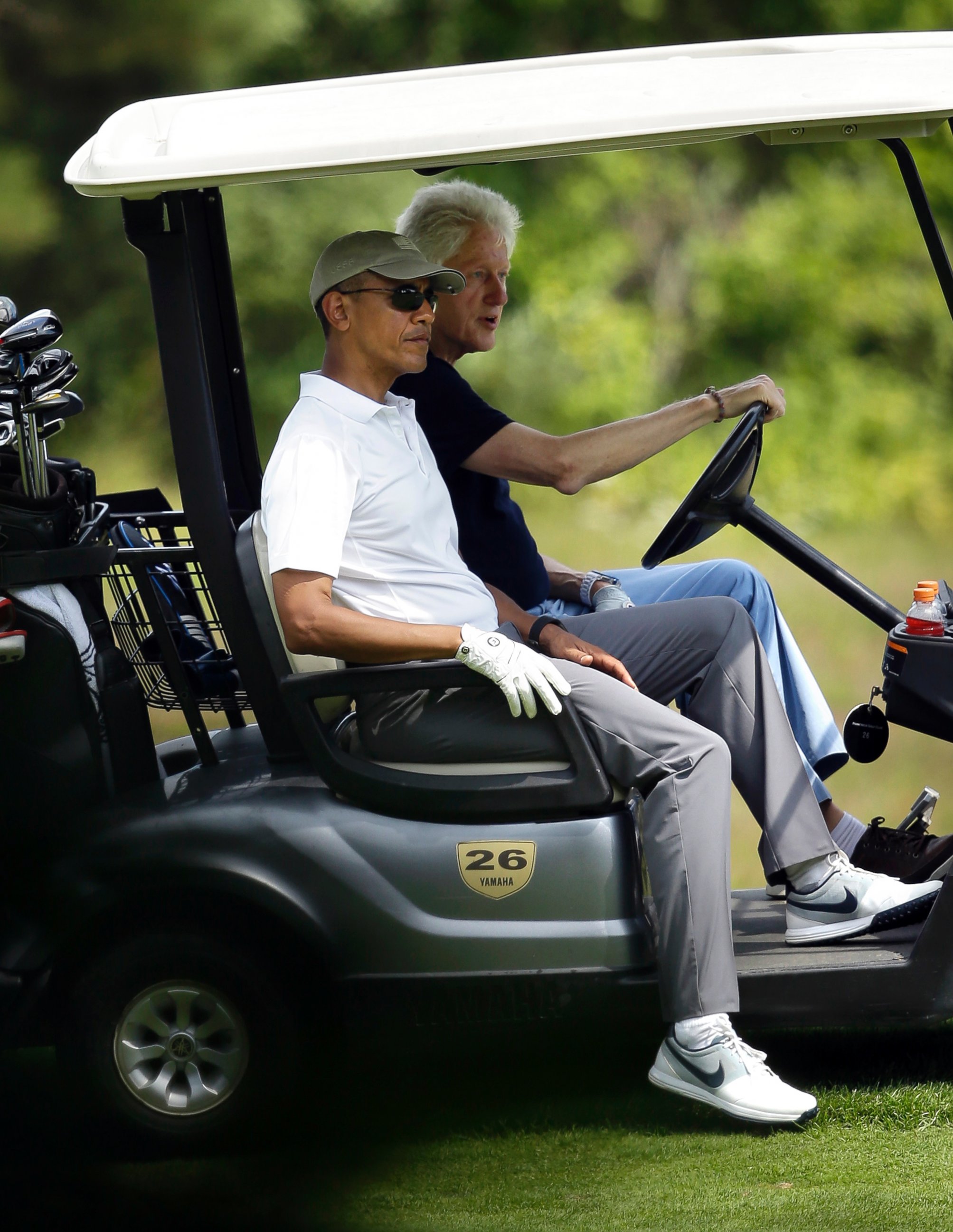 PHOTO: President Barack Obama, front left, and former President Bill Clinton ride in a cart while golfing at Farm Neck Golf Club in Oak Bluffs, Mass. on the island of Martha's Vineyard, Aug. 15, 2015.