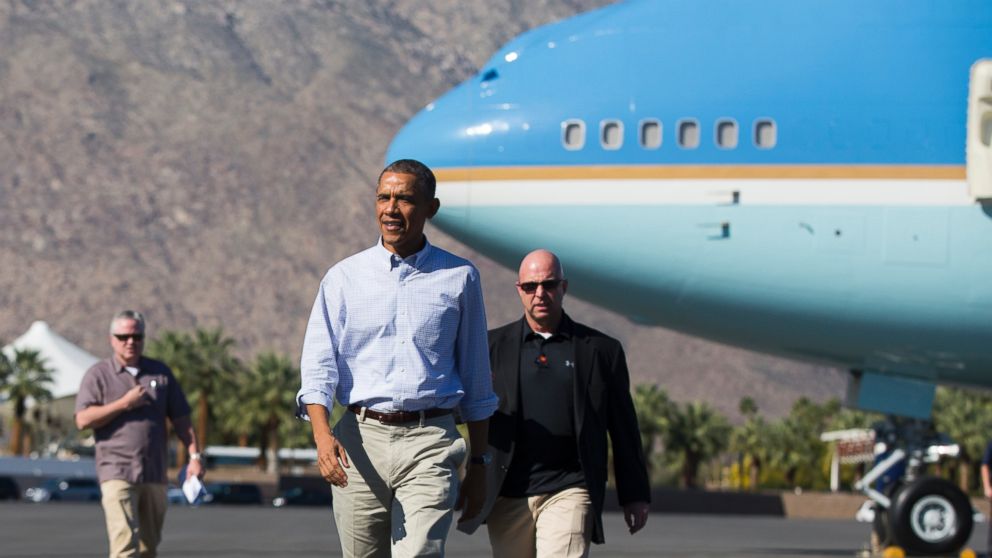 President Barack Obama walks to shake hands with greeters after arriving aboard Air Force One at Palm Springs International airport, on Saturday, Feb. 14, 2015, in Palm Springs, Calif. 